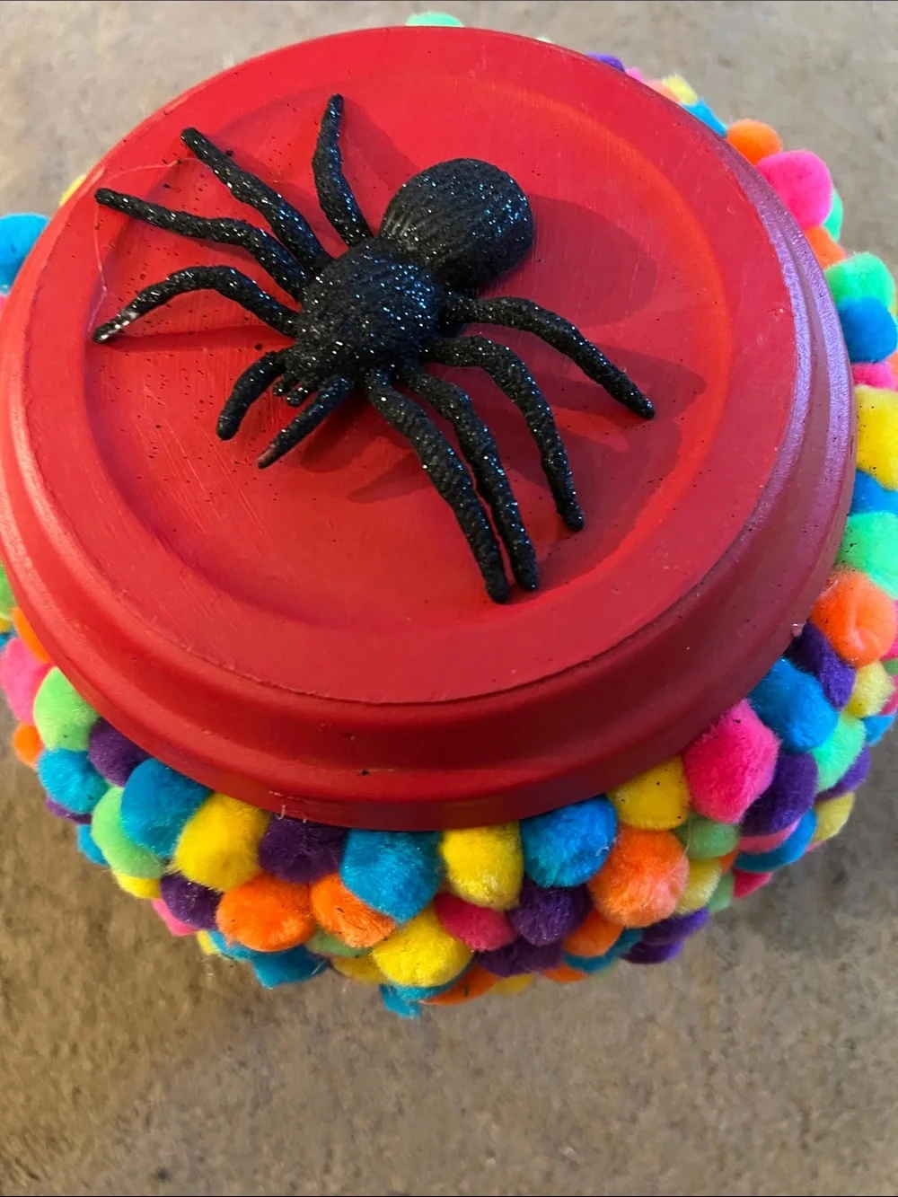 Red Gumball Toy Machine with Multicolor Pom-Pom Cover with Spiders